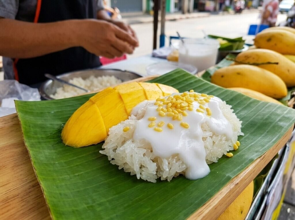 Mango sticky rice with coconut cream on a banana leaf in Bangkok